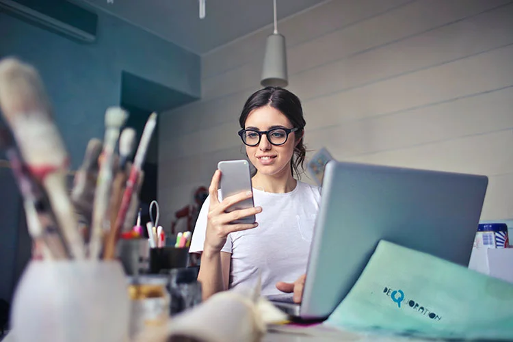 woman with cell phone in art studio